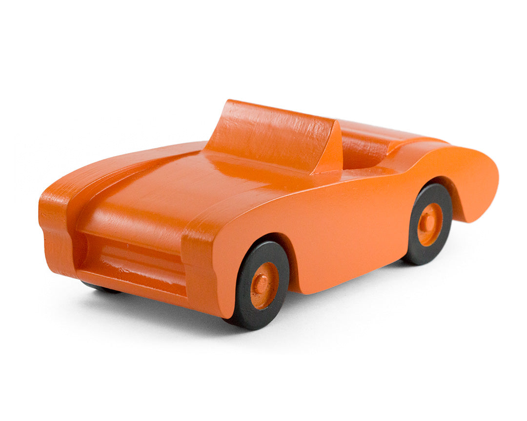 Handcrafted wooden toy car in orange